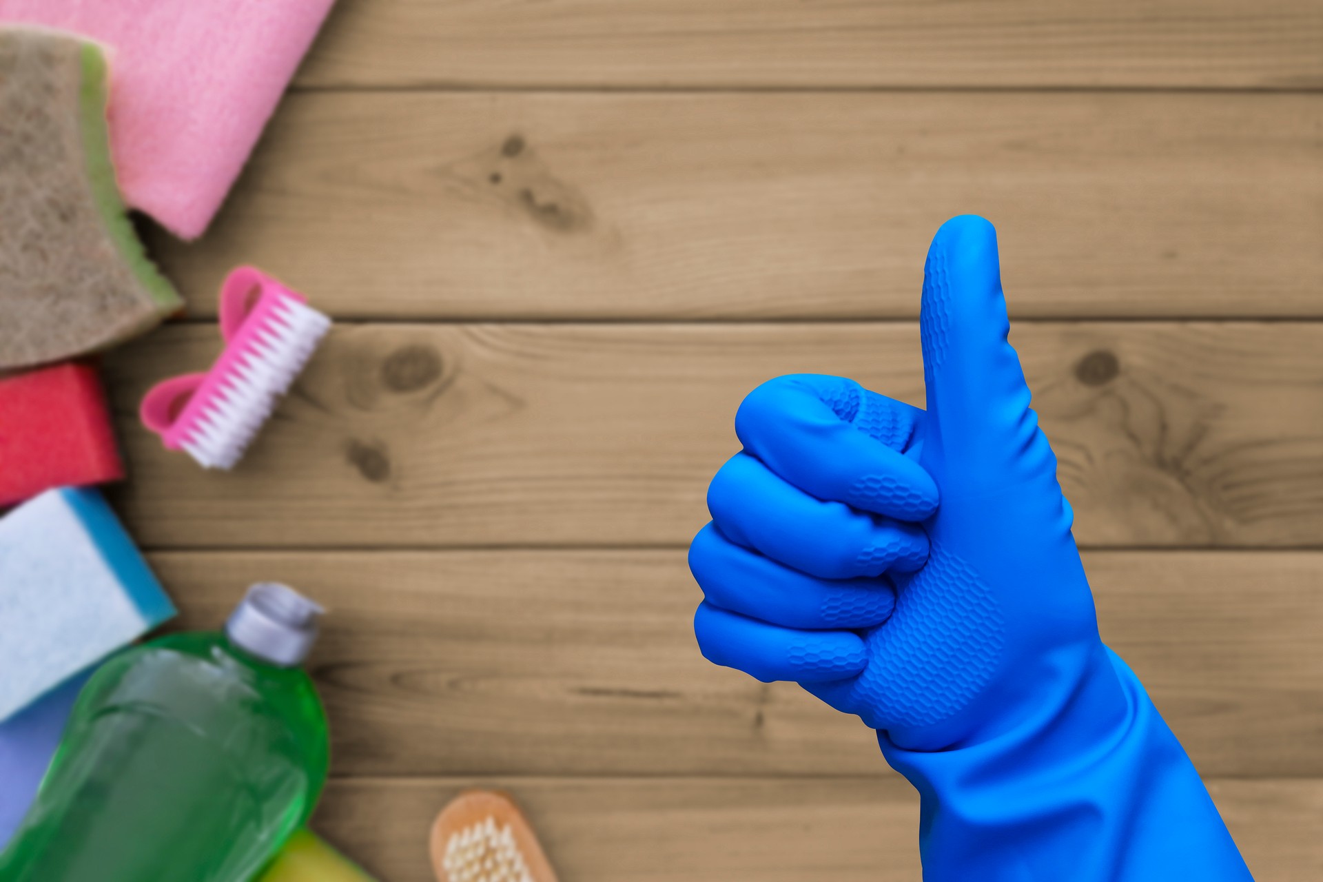 Thumb up against background of cleaning product.